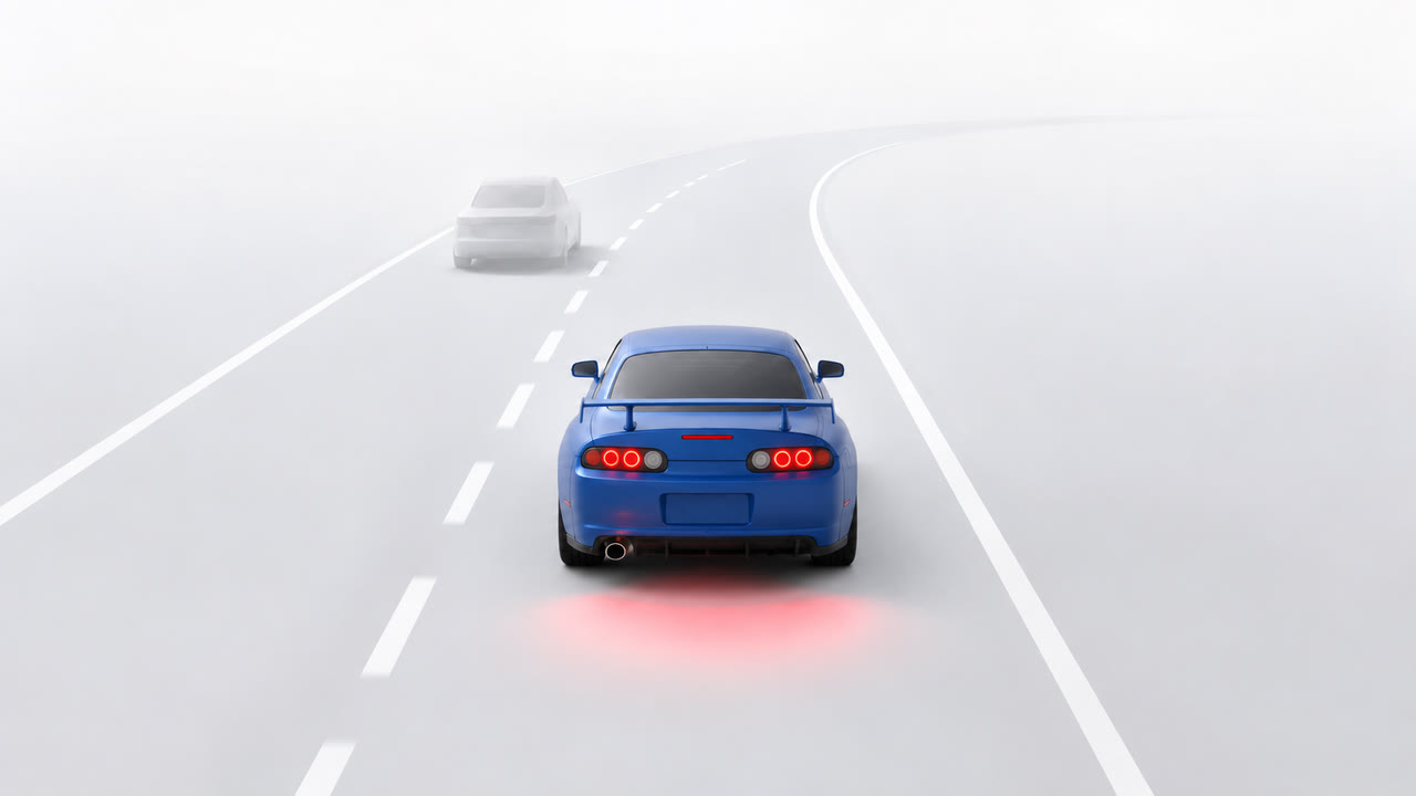 After, with RevEV: the same misty road with a blue sports coupe
